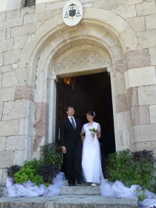 Conor and Caterina after their marriage at the Basilica Santuario dei Ss Vittore e Corona in Feltre. The floral arrangements are pots of basil the bride's father grows in the family garden in the old town walls.
